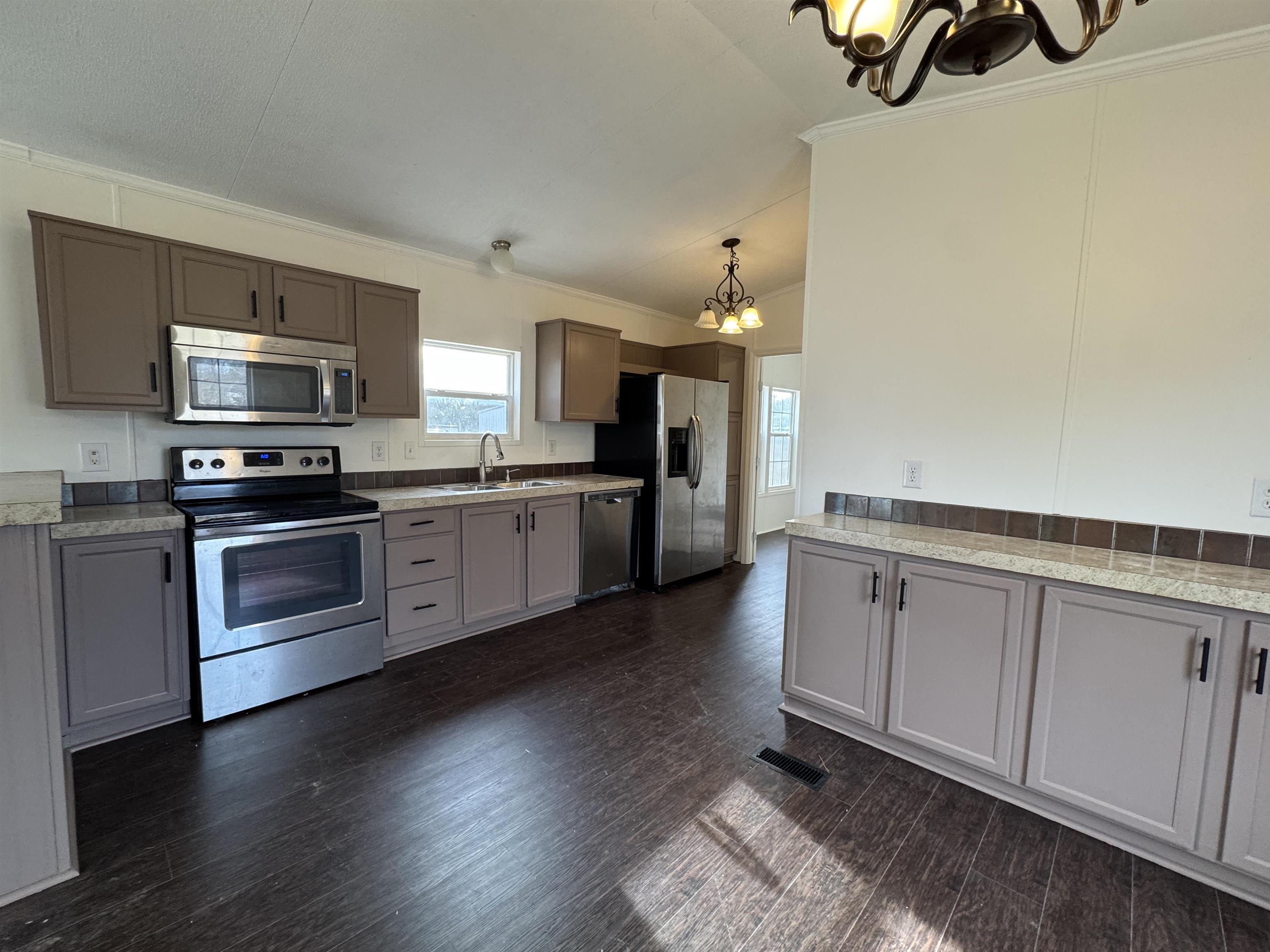 42 Reed Circle Bertram, TX 78605 - Photo 3 of 28 a kitchen with stainless steel appliances granite countertop a stove a sink and a refrigerator