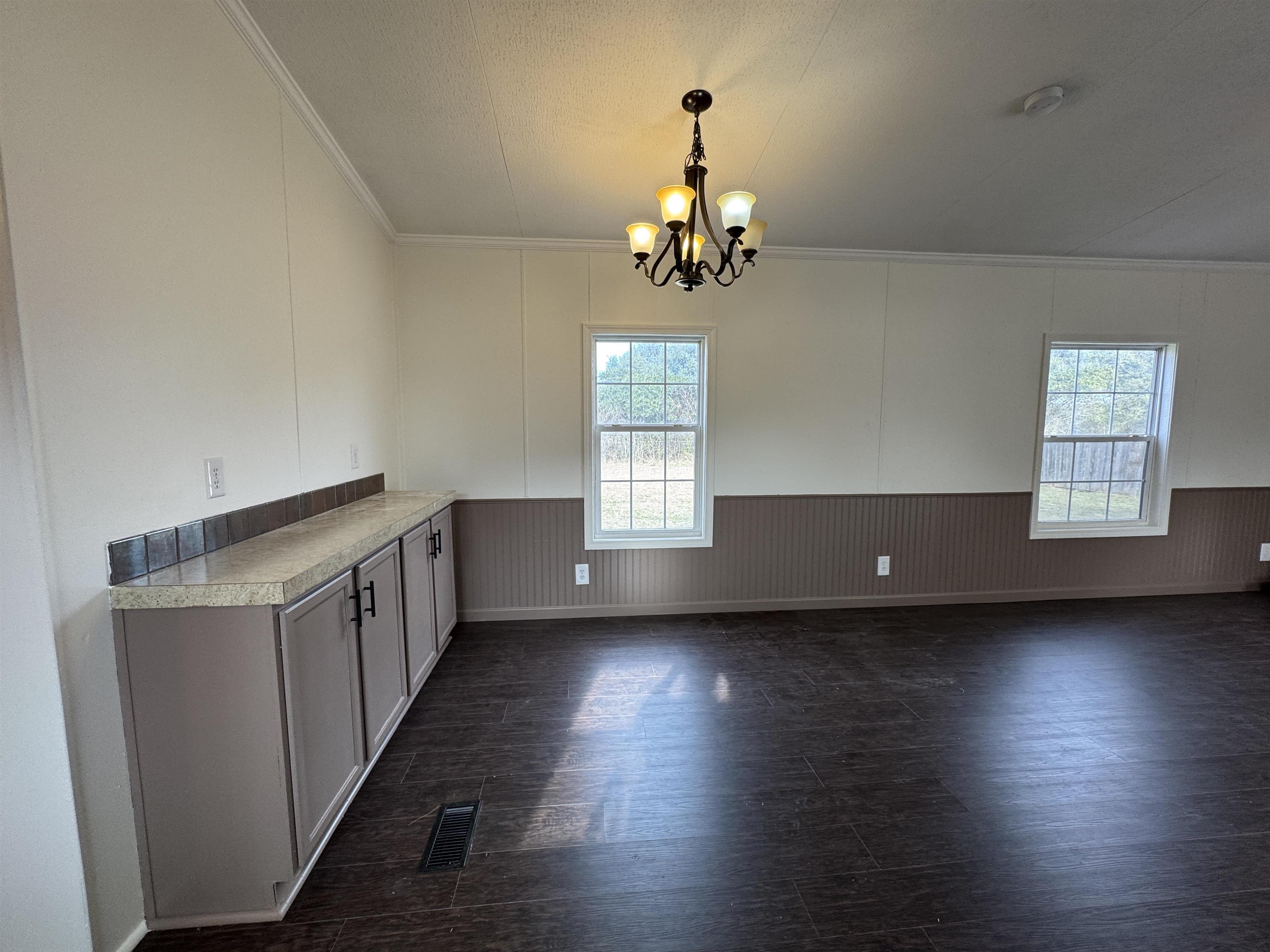 42 Reed Circle Bertram, TX 78605 - Photo 5 of 28 an empty room with wooden floor and windows