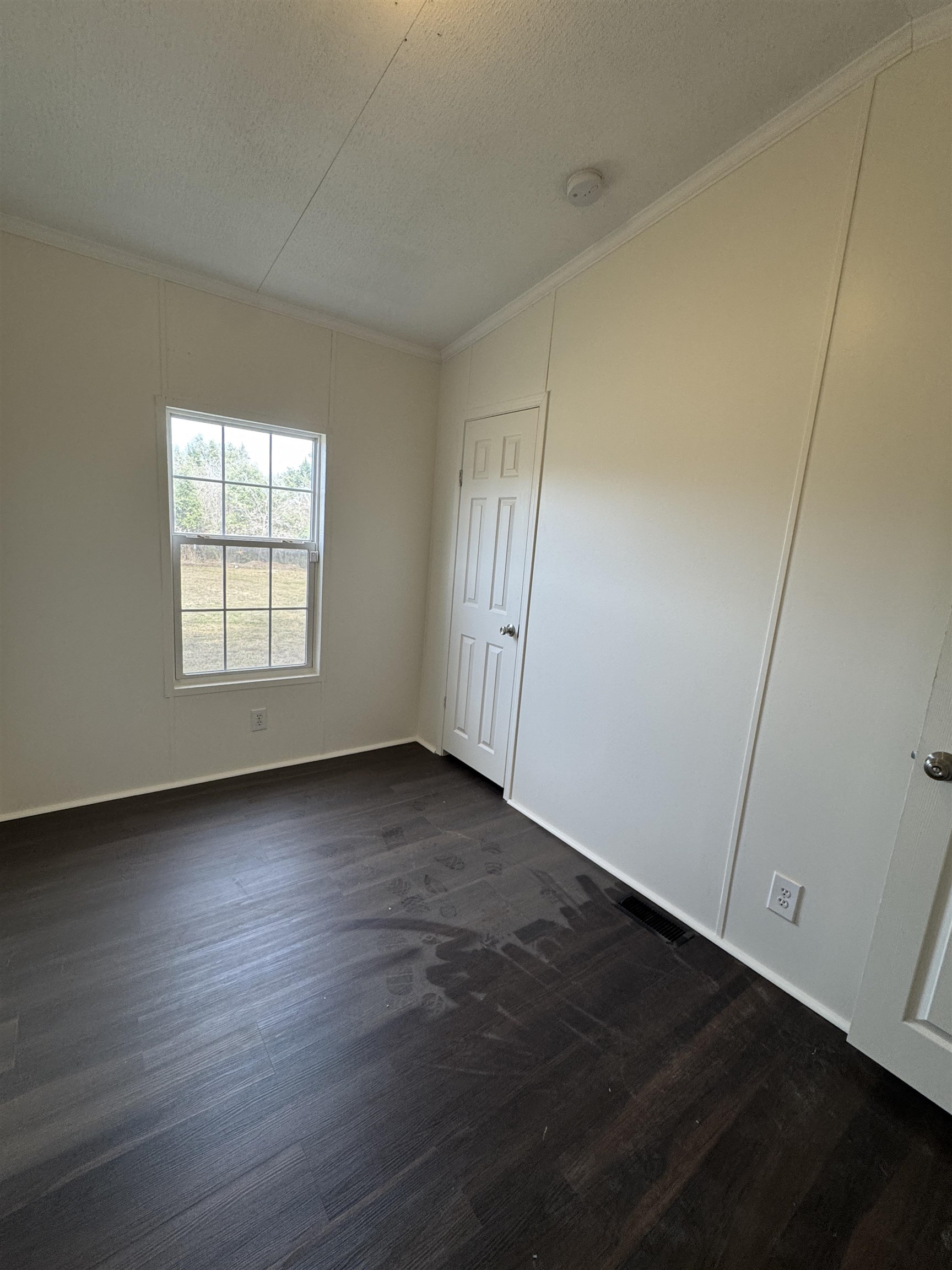 42 Reed Circle Bertram, TX 78605 - Photo 10 of 28 an empty room with wooden floor and window