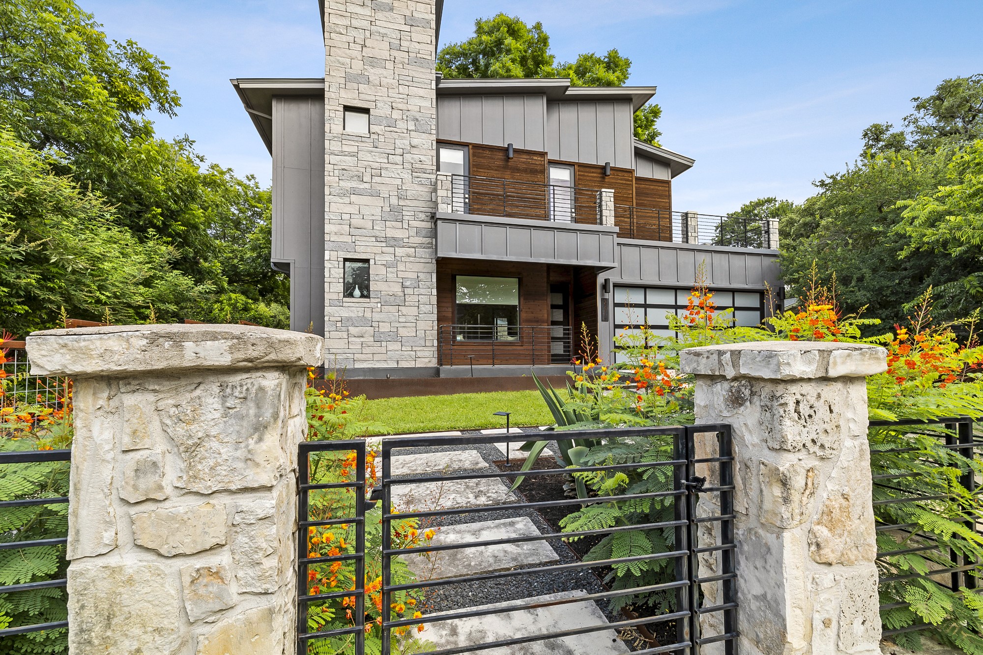 a view of a house with wooden fence