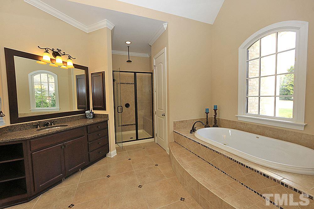 103 Duckhead Point Cary, NC 27518 - Photo 12 of 25 a spacious bathroom with a bathtub sink and mirror