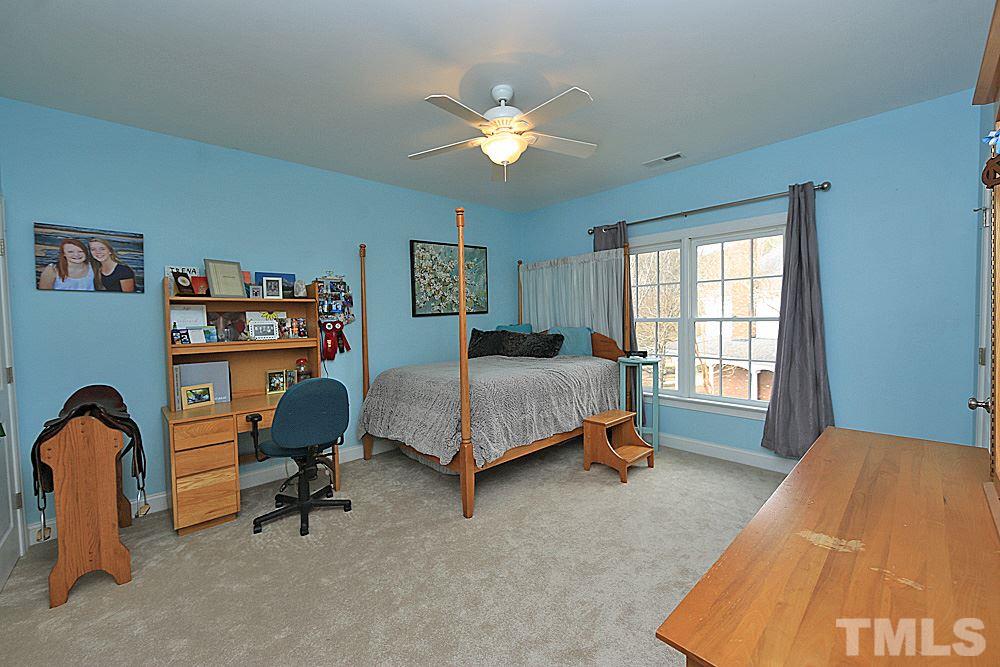 103 Duckhead Point Cary, NC 27518 - Photo 16 of 25 a bedroom with a bed and a chandelier