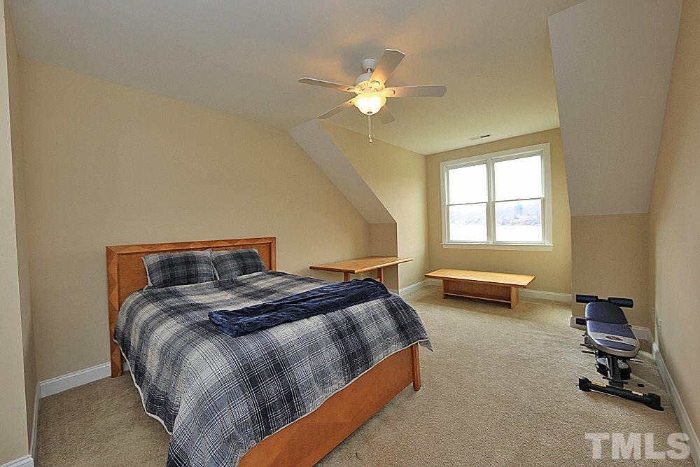 103 Duckhead Point Cary, NC 27518 - Photo 19 of 25 a bedroom with a bed and a chandelier