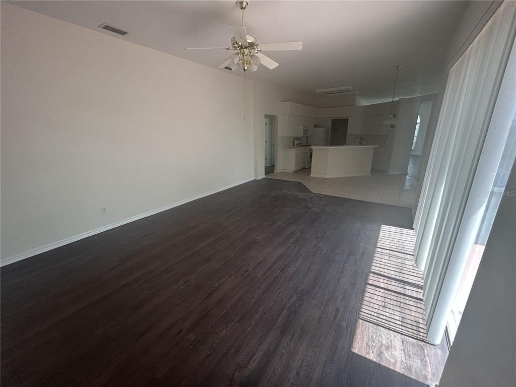 1332 Hatcher Loop Drive Brandon, FL 33511 - Photo 12 of 35 wooden floor in an empty room with a window