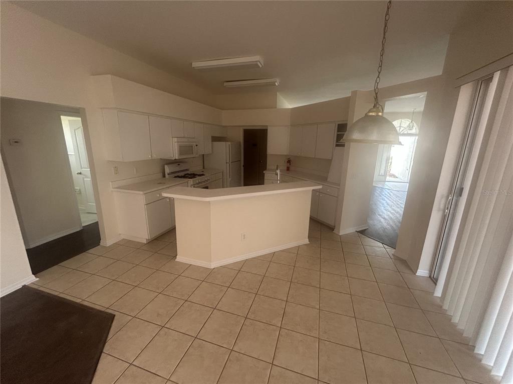 1332 Hatcher Loop Drive Brandon, FL 33511 - Photo 14 of 35 a view of a kitchen with a sink dishwasher and a refrigerator