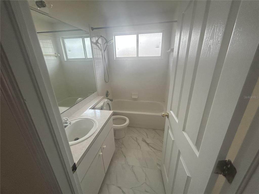1332 Hatcher Loop Drive Brandon, FL 33511 - Photo 17 of 35 a bathroom with a tub a sink and a shower