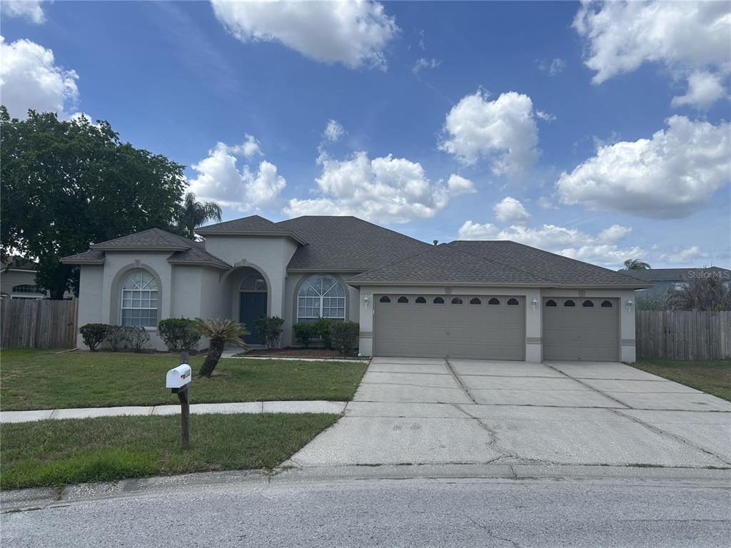 1332 Hatcher Loop Drive Brandon, FL 33511 - Photo 2 of 35 a front view of a house with garden
