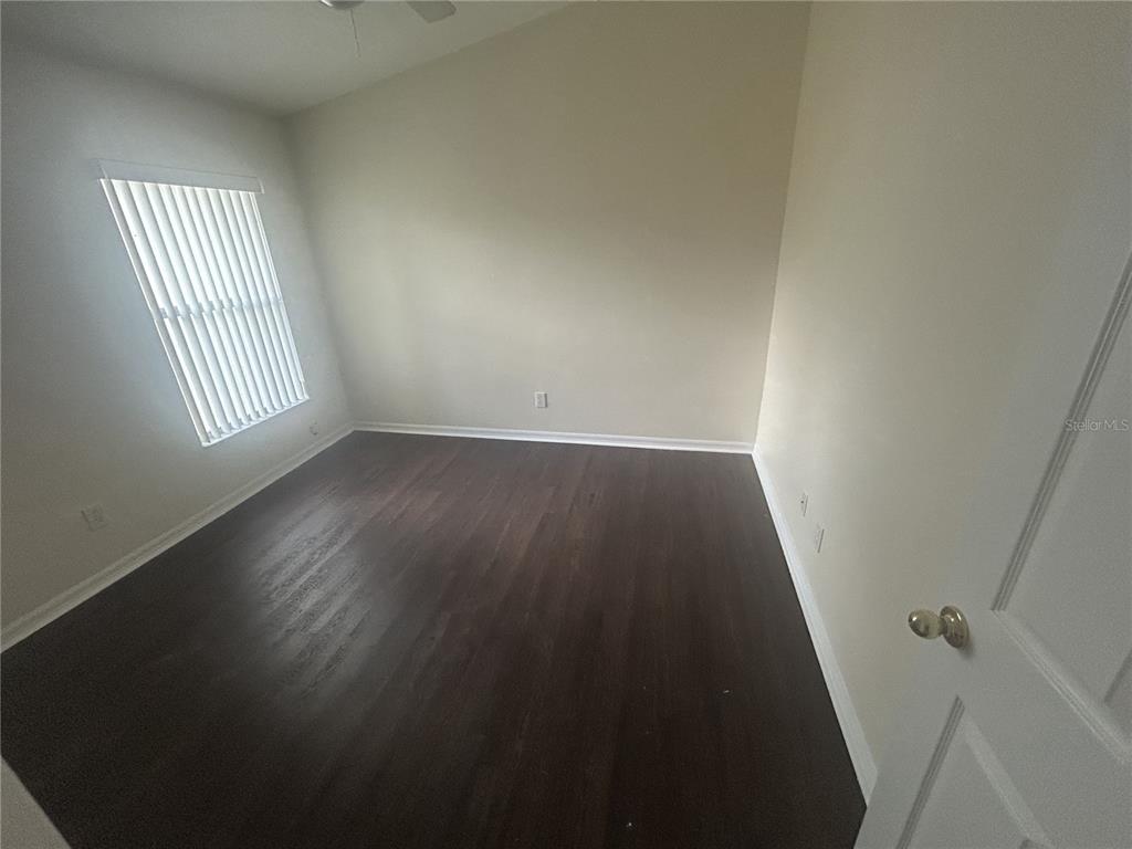 1332 Hatcher Loop Drive Brandon, FL 33511 - Photo 23 of 35 an empty room with wooden floor and windows