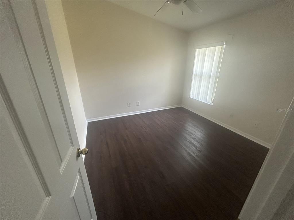 1332 Hatcher Loop Drive Brandon, FL 33511 - Photo 24 of 35 an empty room with wooden floor and windows