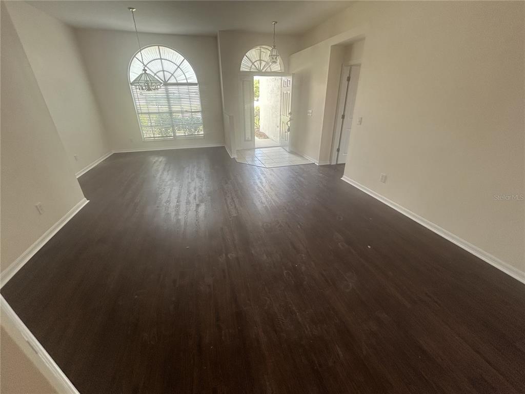 1332 Hatcher Loop Drive Brandon, FL 33511 - Photo 3 of 35 wooden floor in an empty room with a window