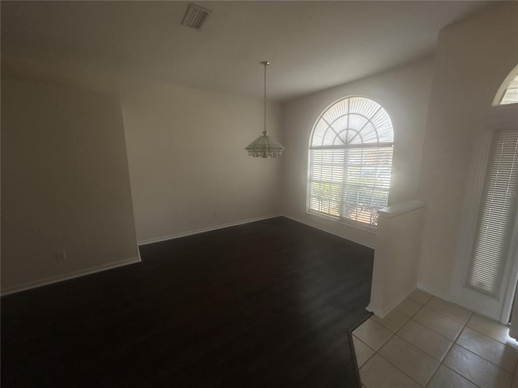 1332 Hatcher Loop Drive Brandon, FL 33511 - Photo 5 of 35 an empty room with wooden floor and windows