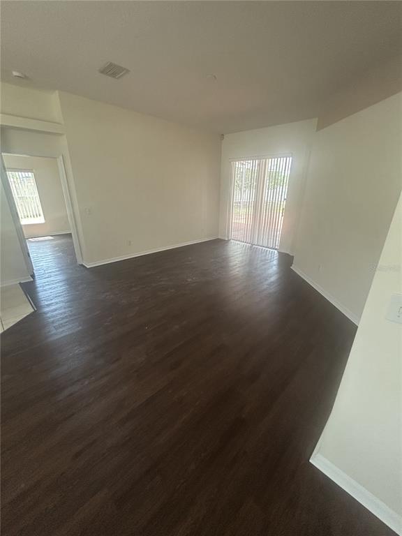 1332 Hatcher Loop Drive Brandon, FL 33511 - Photo 8 of 35 an empty room with wooden floor and windows