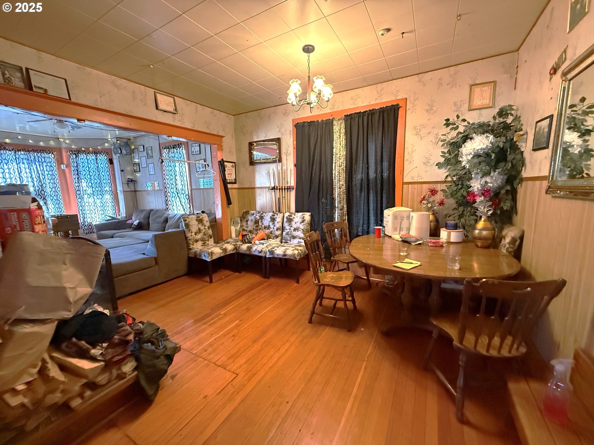 173 North 11th Street Coos Bay, OR 97420 - Photo 5 of 9 a living room with furniture a chandelier and a dining table