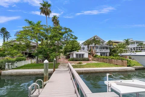 a view of a swimming pool with a patio and a yard