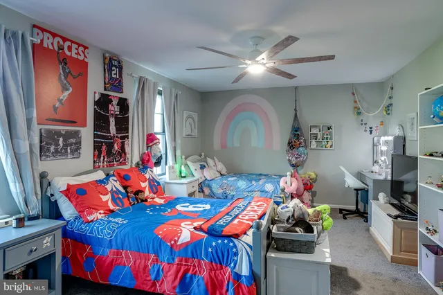 a bedroom with furniture and a baby crib