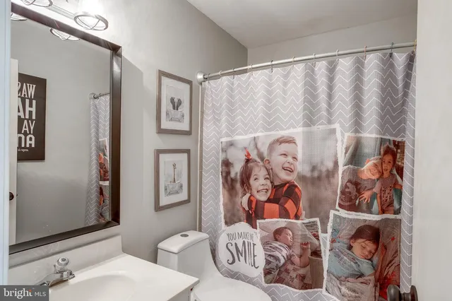 a bathroom with a toilet and a shower curtain