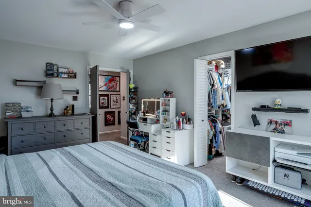 a room with a bed and a flat screen tv