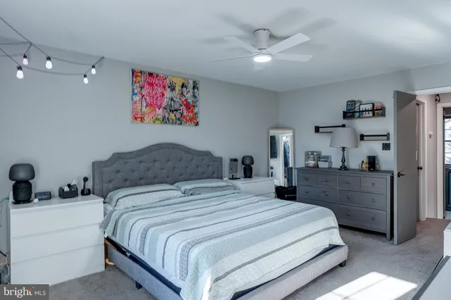 a bedroom with a large bed and a chandelier