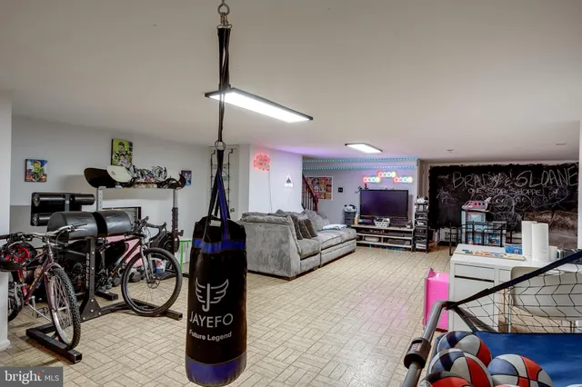 a living room with furniture a air conditioner and a window