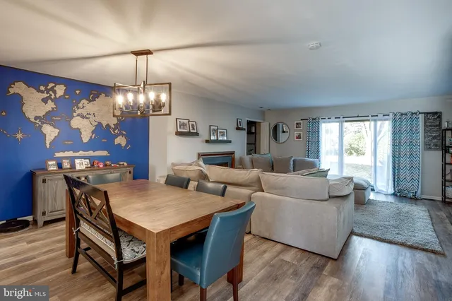 a living room with furniture a chandelier and a window