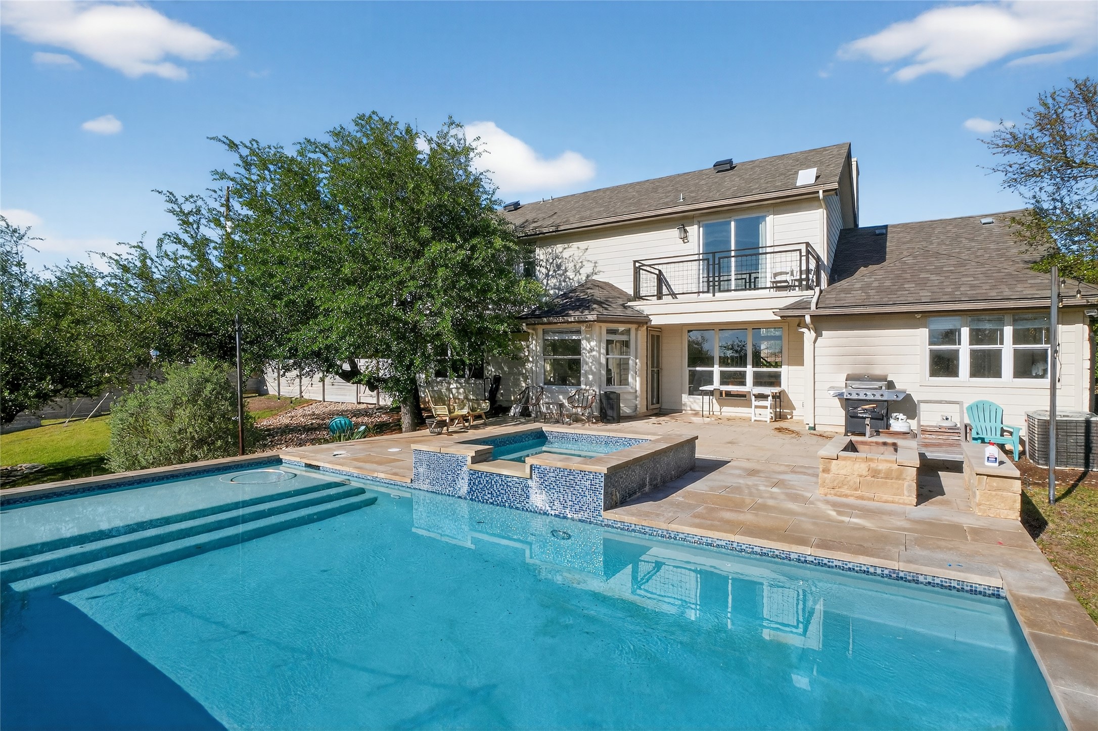 13624 Trautwein Road Austin, TX 78737 - Photo 2 of 38 An inviting backyard oasis offers a sparkling pool and spa, perfect for outdoor entertaining.