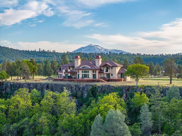 a view of a garden with a large pool table and chairs