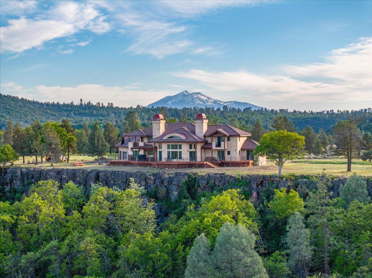 a view of a garden with a large pool table and chairs