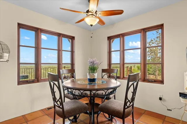a view of a dinning table and chairs in patio of the house