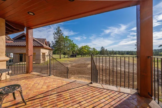 a dining room with furniture and a floor to ceiling window