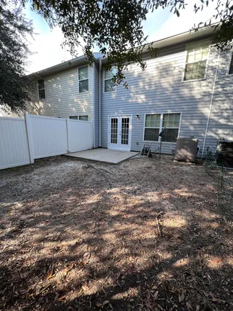 a backyard of a house with table and chairs