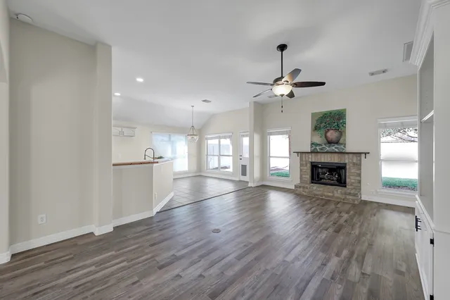 a view of a room with wooden floor and a fireplace
