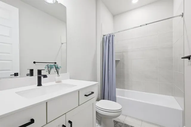 a bedroom with a bed and a dresser with closet