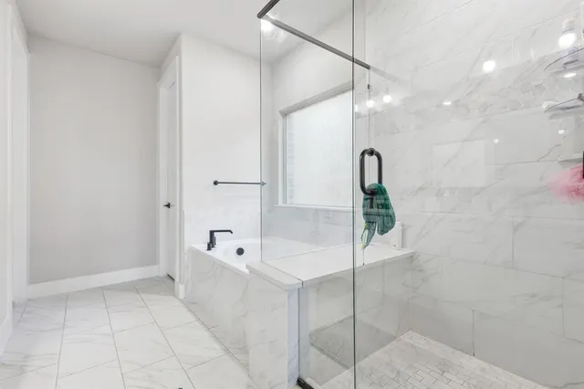 a bathroom with a tub and a shower