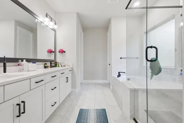 a bathroom with a sink vanity and mirror