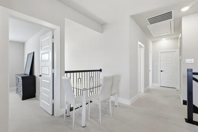 a view of a livingroom with a dinning area wooden floor and staircase