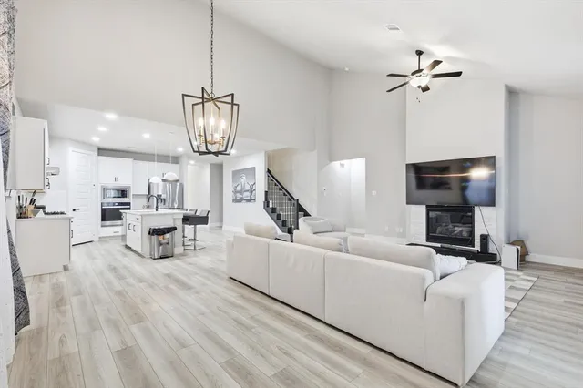 a living room with furniture and a chandelier