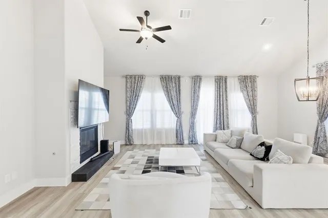 a living room with furniture and a large window