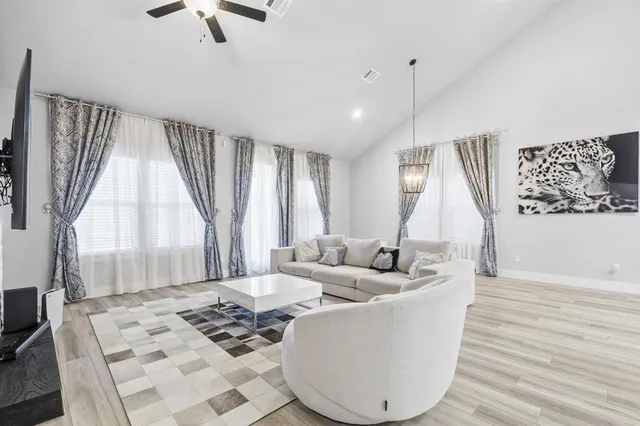 a living room with large window and a wooden floor