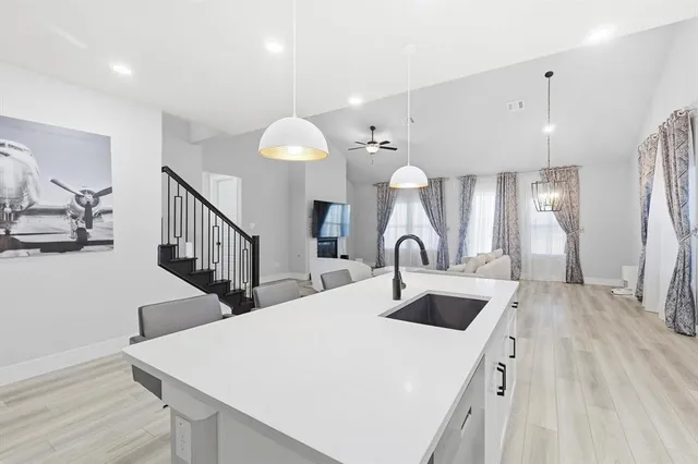 a kitchen with stainless steel appliances a sink stove and cabinets