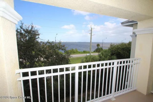 a view of a balcony with yard