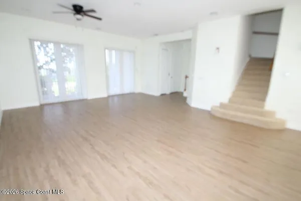 an empty room with windows and closet