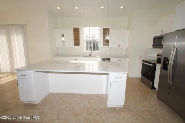 a kitchen with stainless steel appliances a sink stove and refrigerator