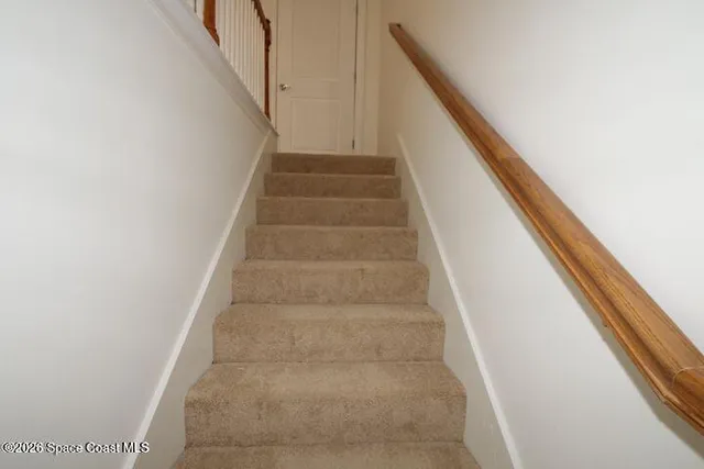 a view of staircase with white walls