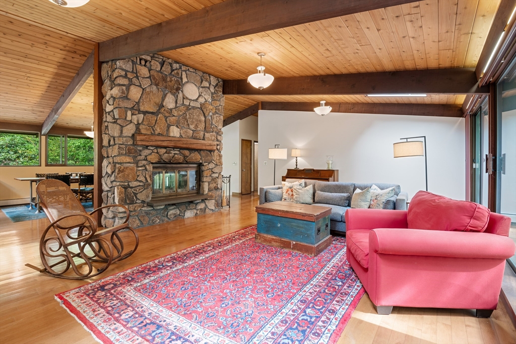 4 Plum Hill Manchester, MA 01944 - Photo 13 of 39 a living room with furniture a rug and a fireplace