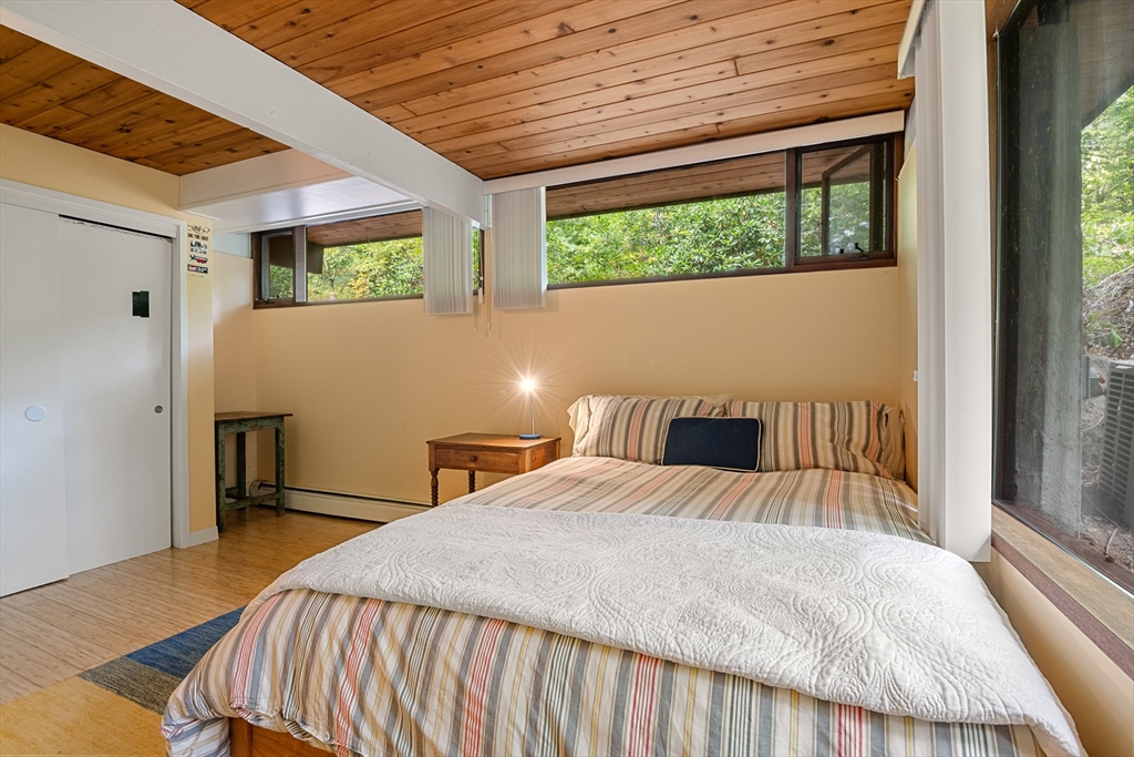 4 Plum Hill Manchester, MA 01944 - Photo 28 of 39 a bedroom with a large bed and a large window