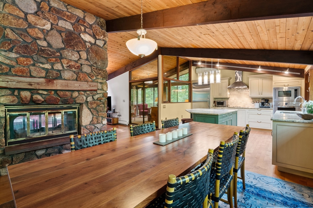 4 Plum Hill Manchester, MA 01944 - Photo 6 of 39 a dining room with furniture a fireplace and wooden floor
