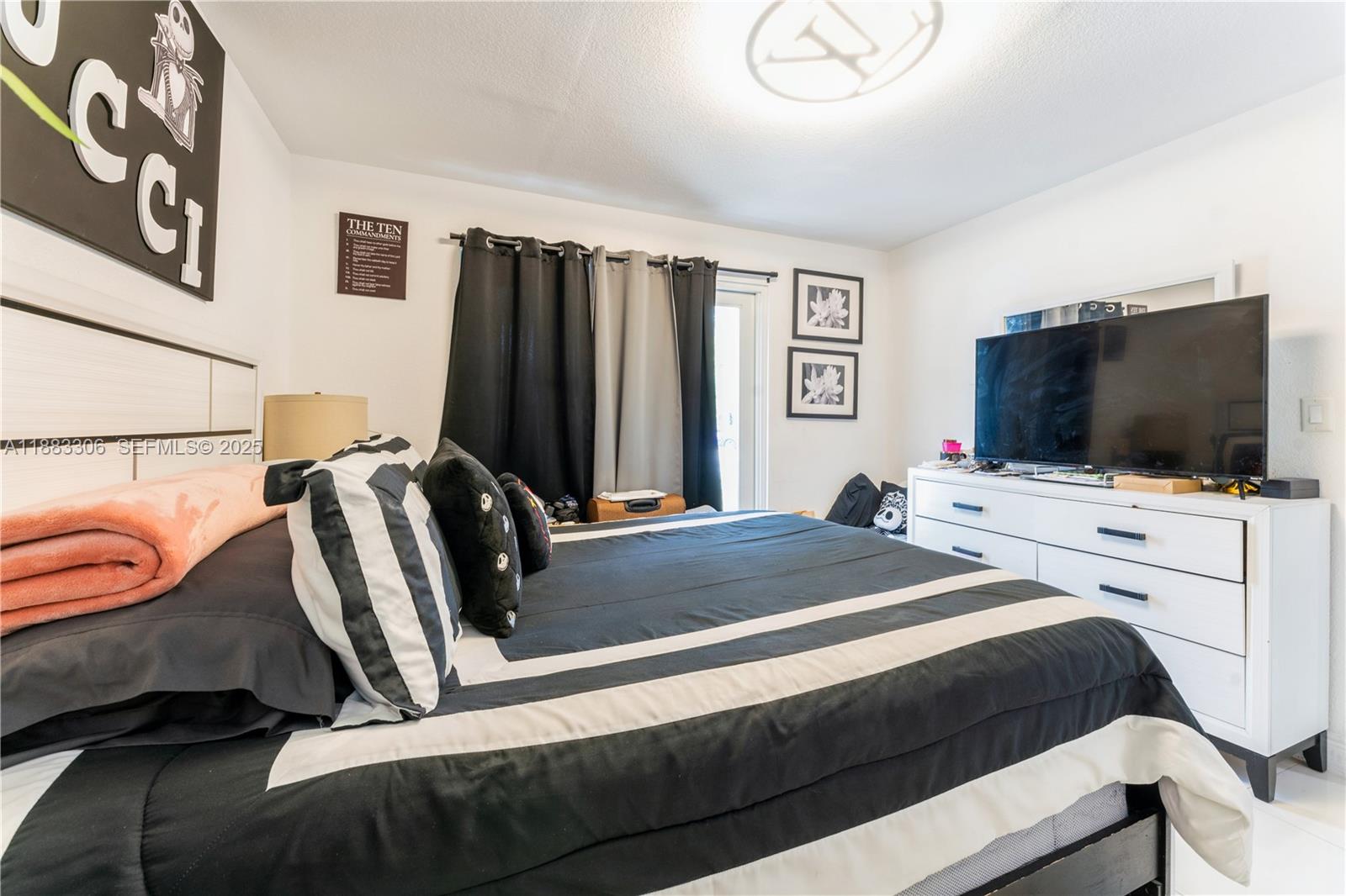 14366 Southwest 258th Lane Homestead, FL 33032 - Photo 11 of 24 a bedroom with a bed and a flat screen tv