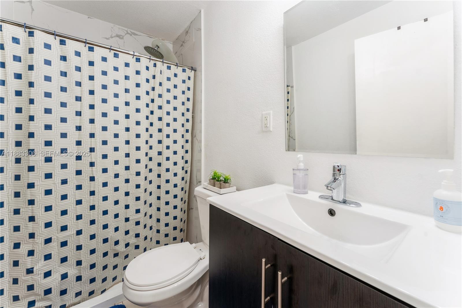 14366 Southwest 258th Lane Homestead, FL 33032 - Photo 12 of 24 a bathroom with a sink a toilet a mirror and shower