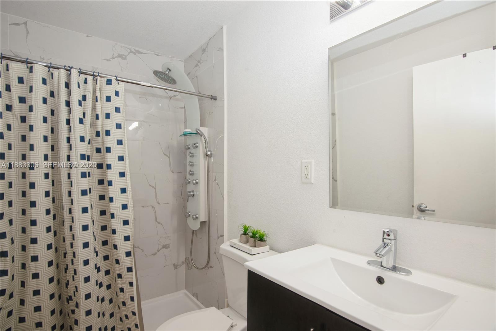 14366 Southwest 258th Lane Homestead, FL 33032 - Photo 13 of 24 a bathroom with a sink a toilet a shower and a mirror