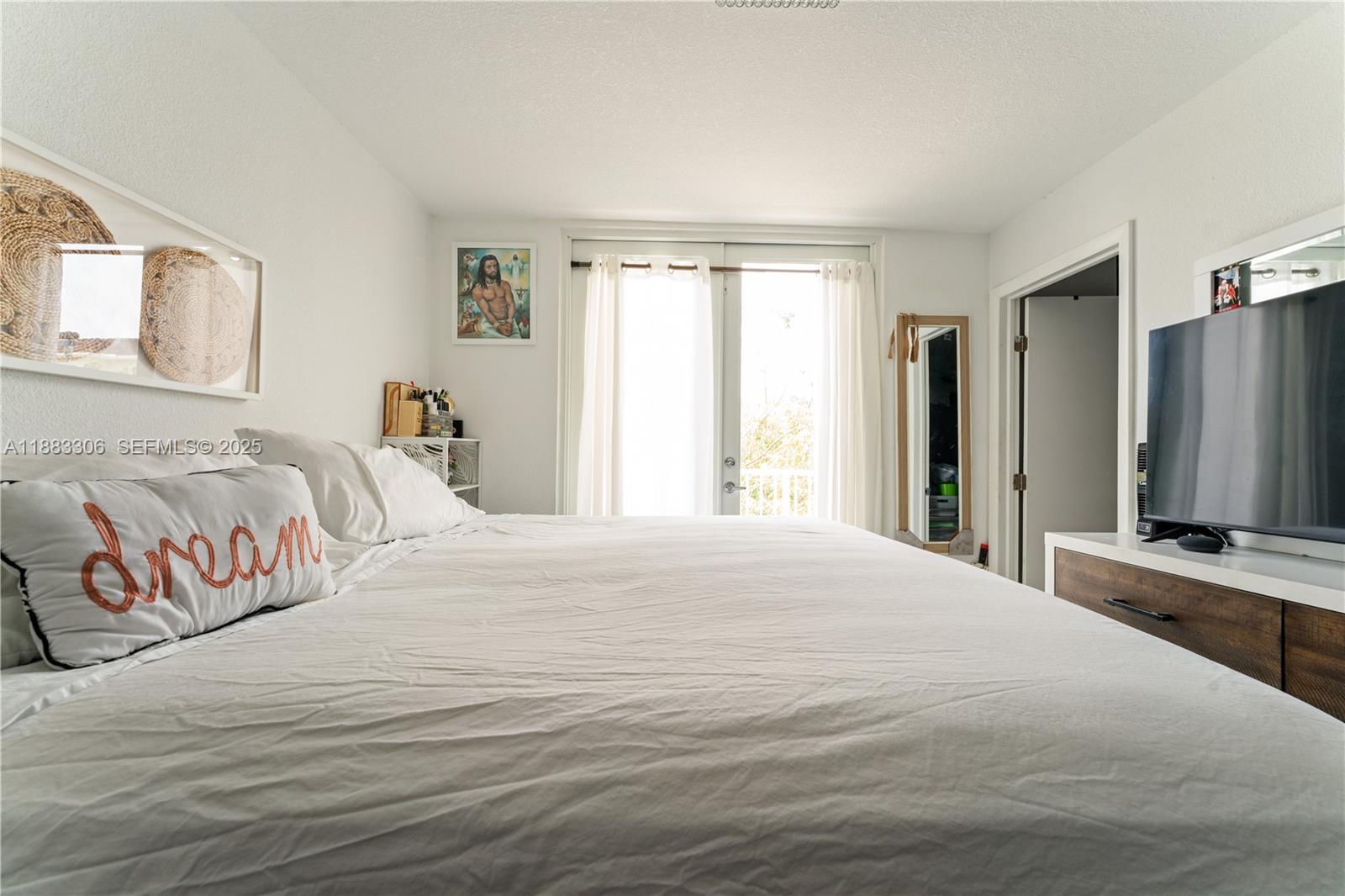 14366 Southwest 258th Lane Homestead, FL 33032 - Photo 16 of 24 a bedroom with a large bed and a flat screen tv